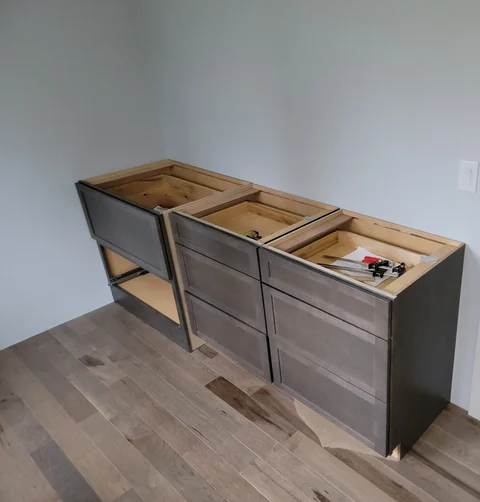Base cabinet installation in progress before countertop installation